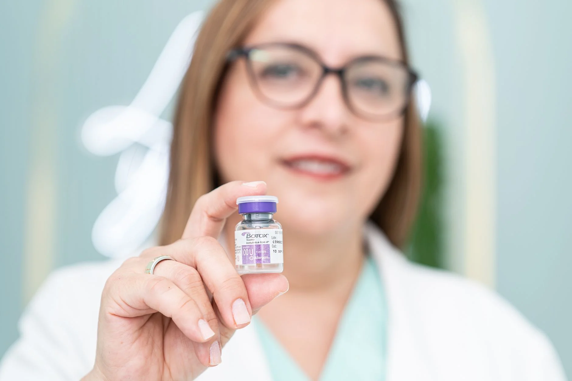 A woman holding a Botox vial, highlighting aesthetic medical cosmetics and beauty treatment. at House of Aetheria, Gurugram